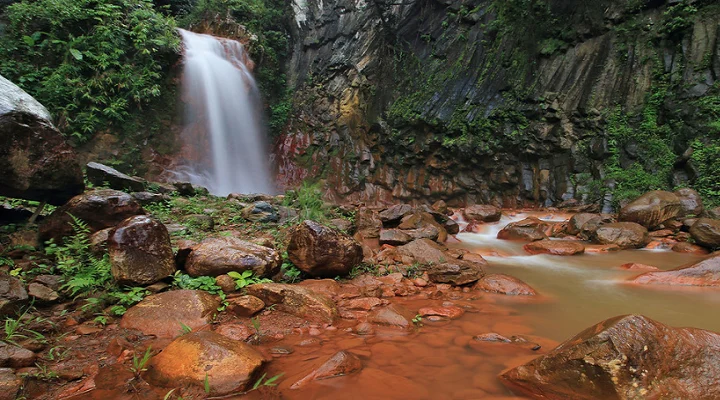 Waterfall over red rocks at Pulangbato Falls, Negros Oriental