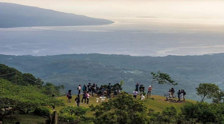 Visitors on the hilltop at Puncak Tanawan above the sea of clouds