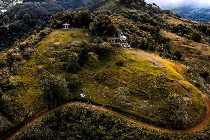 Grassy hilltop with a trail at Puncak Tanawan