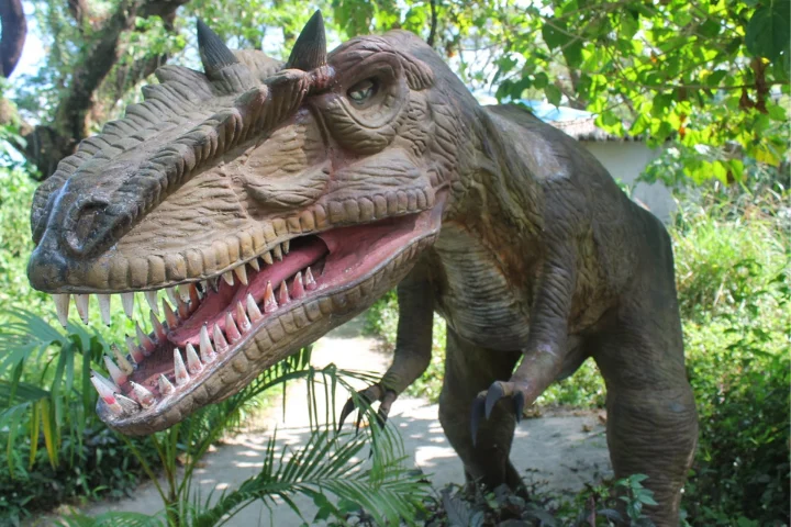 Life-size dinosaur model among the trees at Dinosaur Island, Clark