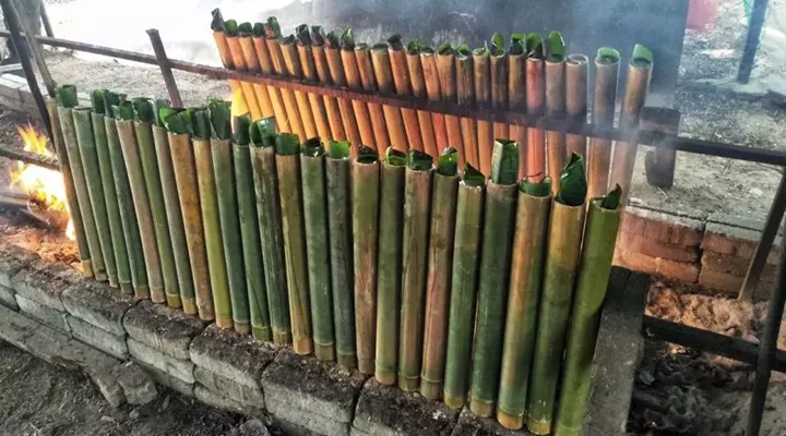 Rice cooking in bamboo tubes over a fire, Pamulaklakin Forest Trail